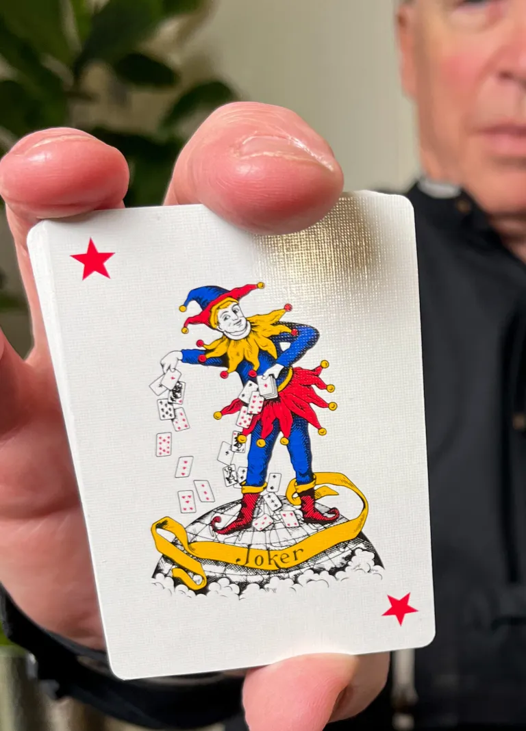 Terry Wood, author of Pokerrailbird.com is holding up a "Joker" as a symbol that there are often funny stories relating to poker.