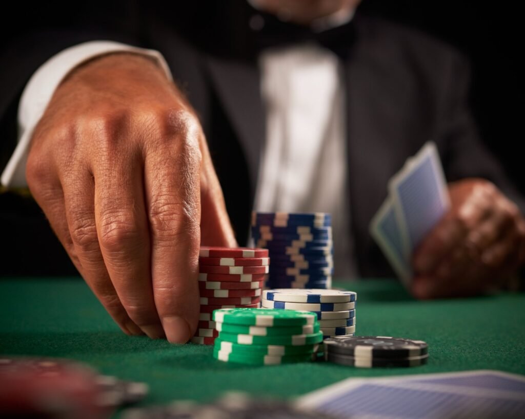 Image of a poker player putting enough chips in the pot to constitute a raise.