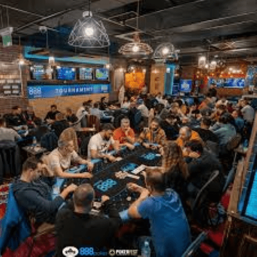Image of a live casino style poker room showing many new players at the tables.